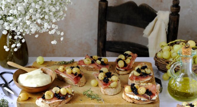 Croutons with Roasted Grapes, Pork Loin, Stracchino and Balsamic Vinegar Pearls